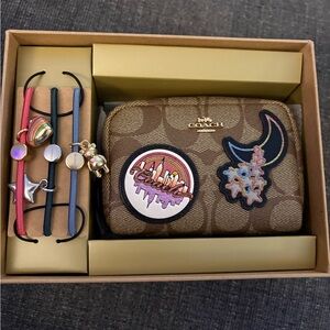 Coach Brown Wristlet with City and Floral Patches